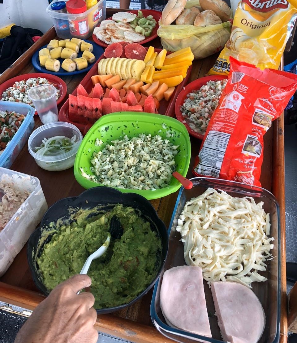 Lunch laid out on the boat between dives, with fresh fruit, guacamole, ceviche, cheese and bread